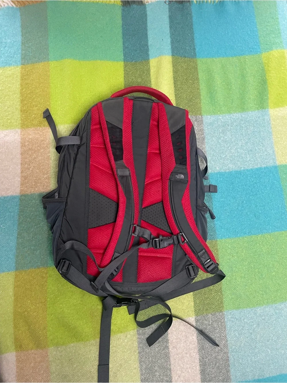 The North Face Recon backpack in charcoal gray and bright red